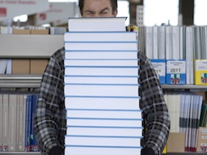 Student carrying books for postgraduate study