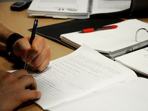 Person writing in workbook