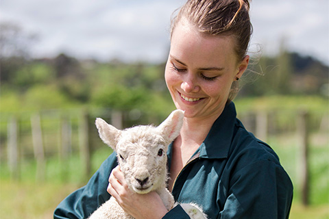 Student holding lamb